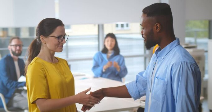 Team leader handshaking employee congratulating with professional achievement