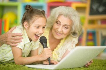 grandmother and daughter singing karaoke