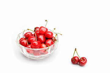 Fresh healthy ripe cherries in glass bowl on white background. Summer sweet seasonal organic fruits. Selective focus.