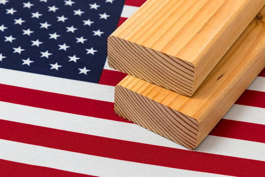 Softwood construction lumber on flag of United States of America. Concept of trade war, tariffs, fair trade and lumber, logging industry