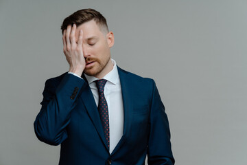 Depressed man in suit feeling sad while receiving bad news