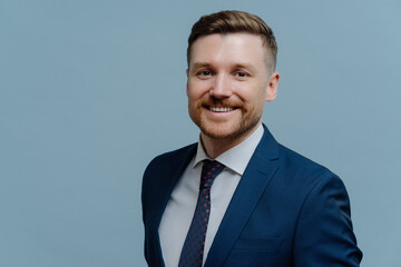 Portrait of happy handsome business man smiling at camera
