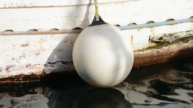 particles of shockproof buoys on the wooden fishing boat hull