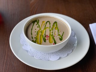 cream soup with mushrooms in a white plate