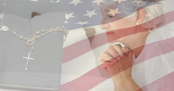 Animation of crucifix rosary bible and woman praying moving over american flag