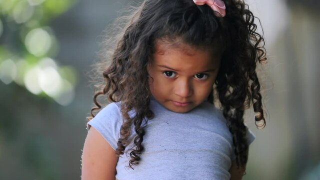 Cute hispanic little girl child. Shy joyful adorable kid