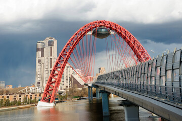 Obraz premium Beautiful cable-stayed Zhivopisny bridge in Moscow, Russia. It is the highest suspension bridge in Europe and landmark of Moscow. Nice panorama of modern buildings in Moscow.