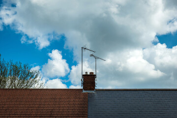 british house roof with chimneys half decorated