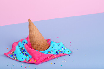 Creative idea made of ice cream cone and  wiping cloth spilled on pastel blue and pink background