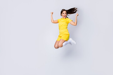 Full length body size view of nice beautiful satisfied crazy energetic glad cheerful cheery lucky straight-haired girl jumping having fun isolated over light white gray pastel color background