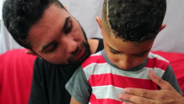 Father consoling sad little boy son