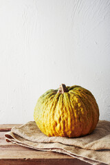 Yellow ripe pumpkin on a wooden table.