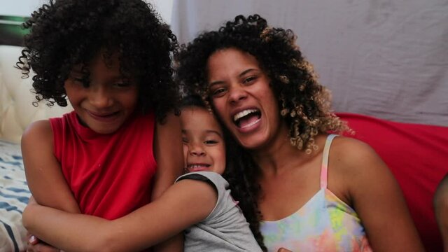 Hispanic happy family, parents and children at home sofa