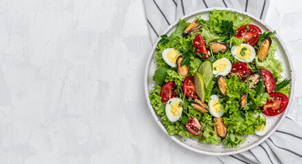 Healthy vegetable salad with mussels, mussels, quail, egg, conjugate, lime, spinach, lettuce, cherry tomatoes and microgreen. Diet menu. Top view