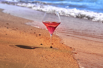 Wine glass with a cocktail by the sea.