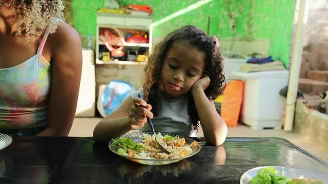 Hispanic little girl eating food, south american latin child lunch
