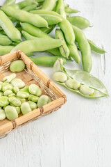 closeup fresh broad beans on a wooden table