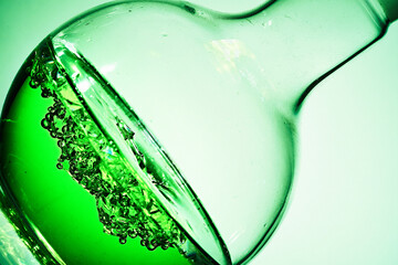 Glass flask. Liquid and crystals. Colored liquid.