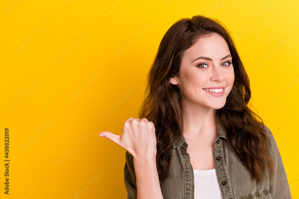 Poster portrait of attractive cheerful girl demonstrating copy empty blank space place solution way isolate