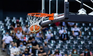 basketball going through the hoop at a sports arena