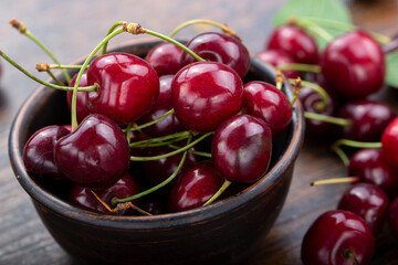 Freshly harvested cherries in a clay bowl from your home garden.