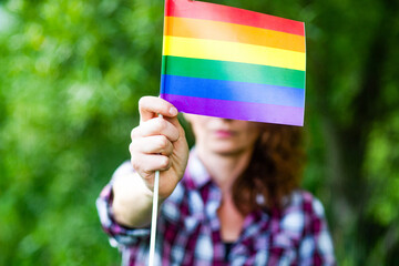 woman holding rainbow flag LGBT rights