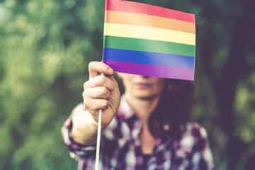 woman holding rainbow flag LGBT rights