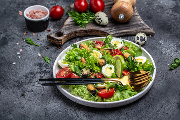 Salad with mussels, quail, egg, conjugate lime, spinach, lettuce, cherry tomatoes and microgreen. Dietary salad. Food recipe background. Close up
