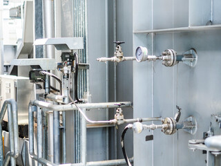 Temperature transmitter for measuring instrument close up in industry zone at power plant.