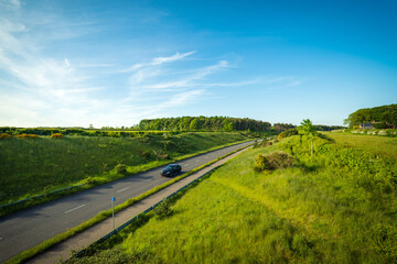 Fototapeta na wymiar car on uk motorway road between countryside fields in england