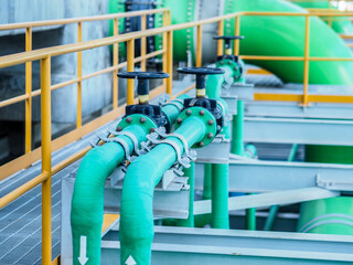 Manual valve and green pipe of cooling water in power plant.