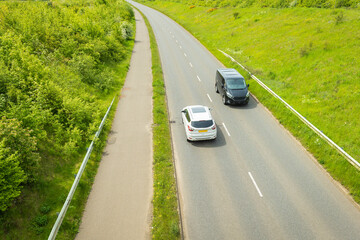 uk motorway road traffic over new build town development in england