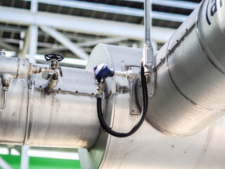 Temperature sensor for measuring instrument close up in industry zone at power plant.