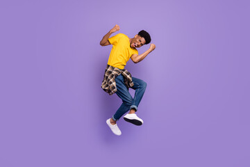Full length body size view of attractive cheerful lucky guy jumping rejoicing isolated over violet purple color background