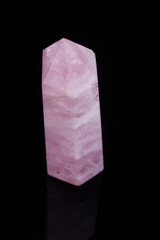Macro mineral pink quartz crystal on a black background