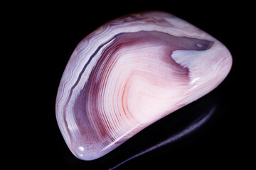 Macro mineral stone Agate pink Persian on a black background