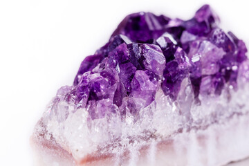 Fototapeta premium Macro mineral stone purple amethyst in crystals on a white background