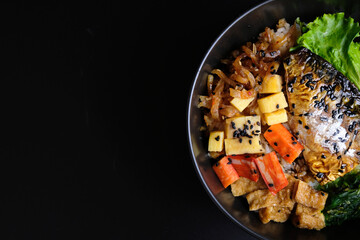 Saba on top of rice. Japanese food style, Saba fish grilled with teriyaki sauce in bowl with black background.