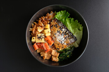 Saba on top of rice. Japanese food style, Saba fish grilled with teriyaki sauce in bowl with black background.
