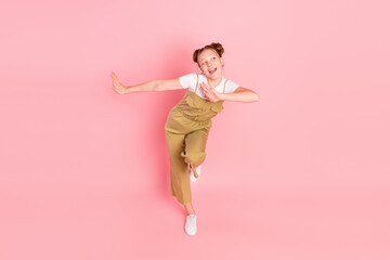 Full length body size view of attractive cheerful girl dancing practicing isolated over pink pastel color background
