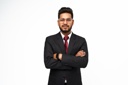 Portrait of young indian businessman with crossed arms on white isolated background