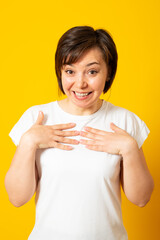 Emotional woman being happy that she was chosen to be leader. Surprised beautiful female pointing at herself..