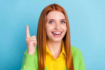 Portrait of attractive cheerful brainy long-haired girl pointing up brilliant idea isolated over bright blue color background