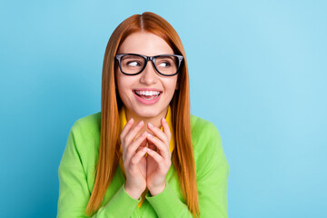 Photo of optimistic red hairdo young lady think look empty space wear spectacles green sweater...