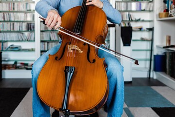 Detail of man touching the cello