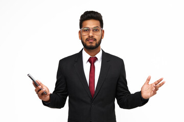 Portrait of surprised young indian business man with mobile phone on white isolated background
