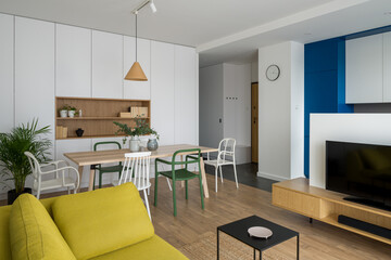 Simple dining table in living room with tv