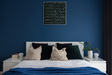 Navy blue wall in bedroom with double bed