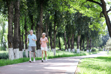 Fototapeta na wymiar Old couple jogging in outdoor park