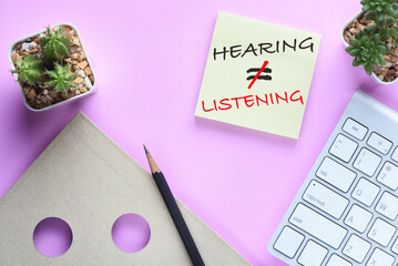 Hearing not equal listening written on sticky notes on modern desk. Communication with understanding concept and soft skill idea